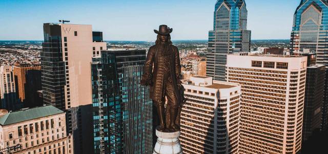 Bronze Statue of Founder of City on Top of Building